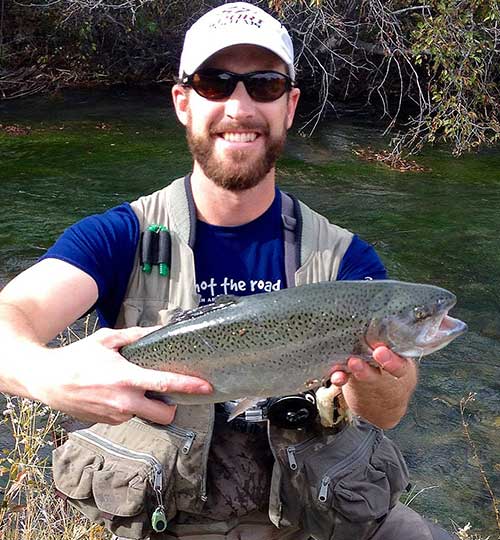 Angler holding a 23-inch rainbow trout caught on the Pecos River New Mexico